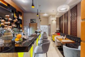 a bar in a hotel with chairs and tables at Hotel Tarnovia in Tarnów