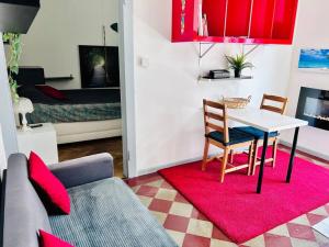 a living room with a table and a couch at Town Center Lugano in Lugano