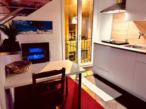 a kitchen with a table and a kitchen with a fireplace at Town Center Lugano in Lugano