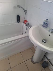 a bathroom with a sink and a tub and a toilet at great holidays hemsby in Hemsby