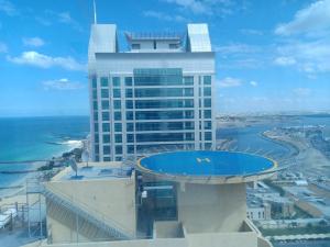 a building with a swimming pool on top of it at 22 R4 Single 1 small room in a 4-bedroom apartment with attached bathroom suitable for one person ### 22 R4 1 غرفة صغيرة في شقة مكونة من 4 غرف نوم مع حمام ملحق مناسبة لشخص واحد in Ajman 