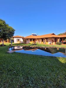 a house with a pond in front of it at Pousada das Missoes in São Miguel das Missões