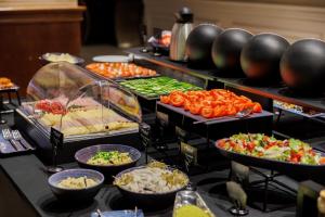 a buffet with many different types of food on display at Hotel Tarnovia in Tarnów