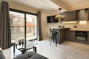 a kitchen and living room with a couch and a table at Kefalonia Luxury Maisonette in Argostoli +34 photos