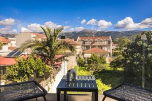 a balcony with two benches and a view of a city at Kefalonia Luxury Maisonette in Argostoli