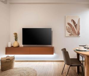 a living room with a flat screen tv on a wall at Delightful Sense 2BD Apt in Kolonaki 7 min to Metro in Athens