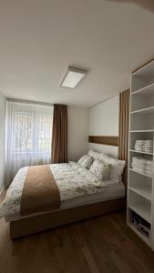 a bedroom with a large bed and a window at Sarajevo Charm Apartment in Sarajevo