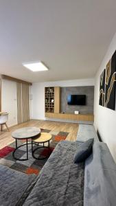 a bedroom with a bed and a table and a tv at Sarajevo Charm Apartment in Sarajevo