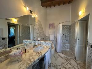 a large bathroom with a sink and a shower at La Corte di Ronzano in Scarperia