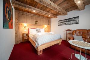 a bedroom with a bed and a table and a chair at Tatrachalet Lomnica Rent in Vysoke Tatry - Tatranska Lomnica.