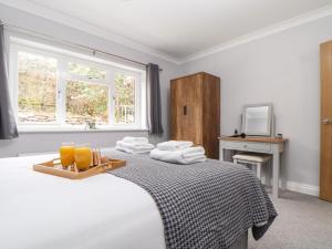 a bedroom with a bed with a tray of orange juice at Lakeside in Falmouth