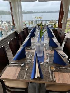una mesa larga con servilletas azules y cubiertos en Mobilheim Summer Lounge Appartment I en Borgdorf-Seedorf