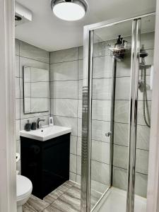 a bathroom with a shower and a sink and a toilet at Rooms Near Me - Apartment 1, Sky Tv, Free Parking 