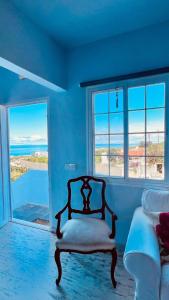 a bedroom with a bed and two windows with a view at Villa Los Aguacateros in Tazacorte