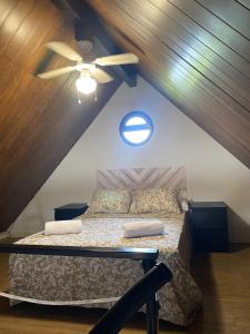 a bedroom with a bed with a ceiling fan at Casas ROBRA in El Palmar