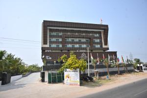 a large building with a sign in front of it at Hotel krishna in Nizāmābād