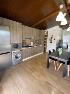 a kitchen with a dining table and a refrigerator at Casas ROBRA in El Palmar