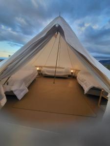 a white tent with two beds in it at Sabático Glamping in Tunuyán