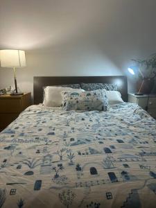 a bed with a blue and white quilt on it at You won't believe the balcony! in Melbourne