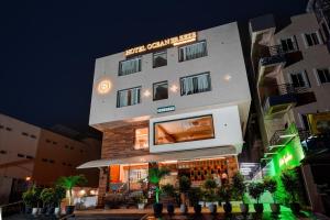 a building with a bar in front of it at night at Palette - Hotel Ocean Breeze in Bhopal