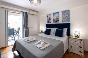 a bedroom with a bed with two towels on it at KG Acropolis Escape Spa Apartment in Athens