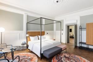 a hotel room with a bed and a living room at Hotel Astoria Wien in Vienna