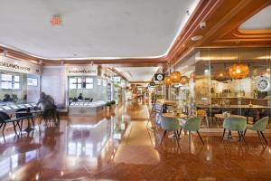 a restaurant with chairs and tables in a building at High Rise Comfort with Balcony in Miami