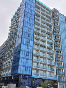 a tall building with many windows at Hotel Black Sea in Batumi