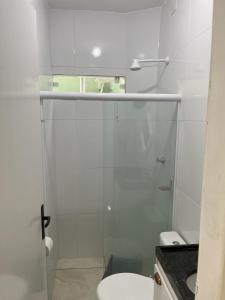 a bathroom with a glass shower with a toilet at Casa 3 Quartos, 2 suites, piscina e sossego in São José da Coroa Grande