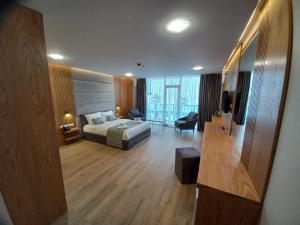 a hotel room with a bed and a living room at Hotel Black Sea in Batumi