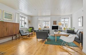 a living room with a couch and a table at 4 Bedroom Cozy Home In Løgstør in Løgstør