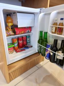 an open refrigerator filled with lots of food and drinks at Hotel Black Sea in Batumi