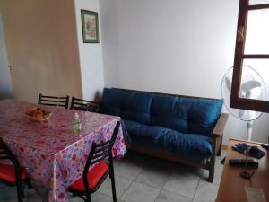 a living room with a blue couch and a table at Cabañas Alicia in San Rafael