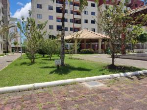 a park with trees in front of a building at Recanto Junto a Praia in Aracaju