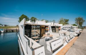 a group of boats docked at a dock in the water at Hausboot Relax in Sagard