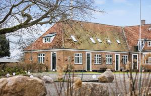 a large brick building with a red roof at Beautiful Apartment In Aakirkeby With Wifi in Åkirkeby