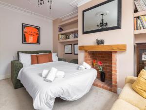 a bedroom with a large bed and a fireplace at Mulberry House in Lytham St Annes