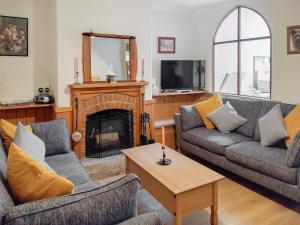 a living room with two couches and a fireplace at Harbour Hill in Chickerell