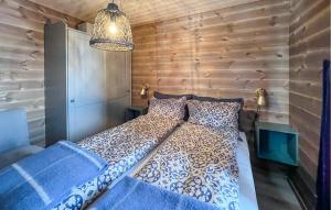 a bed in a room with a wooden wall at 4 Bedroom Stunning Home In Svingvoll in Svingvoll