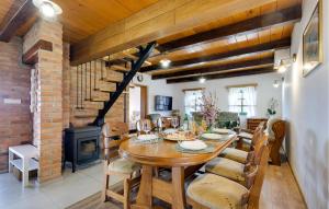 a dining room with a wooden table and a brick wall at Amazing Home In Podgorje Bistricko With Kitchen in Marija Bistrica