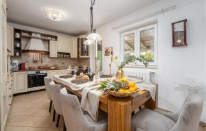 a kitchen with a table with a bowl of fruit on it at Villa Duga in Poreč