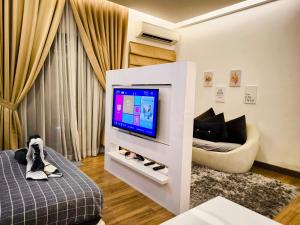 a living room with a tv and a couch at Eshue Designer Suites @ Simfoni Towers in Cheras