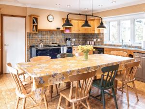 a kitchen with a dining table and chairs at Cranny Hill in Walpole