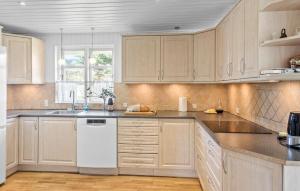 a kitchen with white cabinets and a white dishwasher at 3 Bedroom Beautiful Home In Vordingborg in Vordingborg