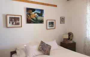 a bedroom with a bed and pictures on the wall at Beach Front Home In Gradac With House Sea View in Gradac