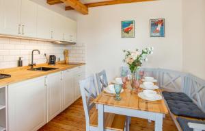 a kitchen with a wooden table with flowers on it at Awesome Home In Rowy With Wifi in Rowy