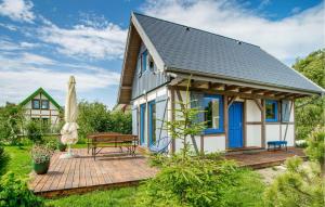 a small cottage with a deck and a table at Awesome Home In Rowy With Wifi in Rowy