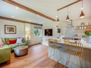 a kitchen and living room with a couch and a table at Keeds Barn in Arundel