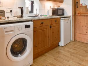 a kitchen with a washing machine and a microwave at Uk46717 - The Orchard in Plumstead
