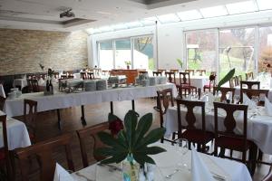 a dining room with white tables and chairs at Marienhof in Unterkirchbach